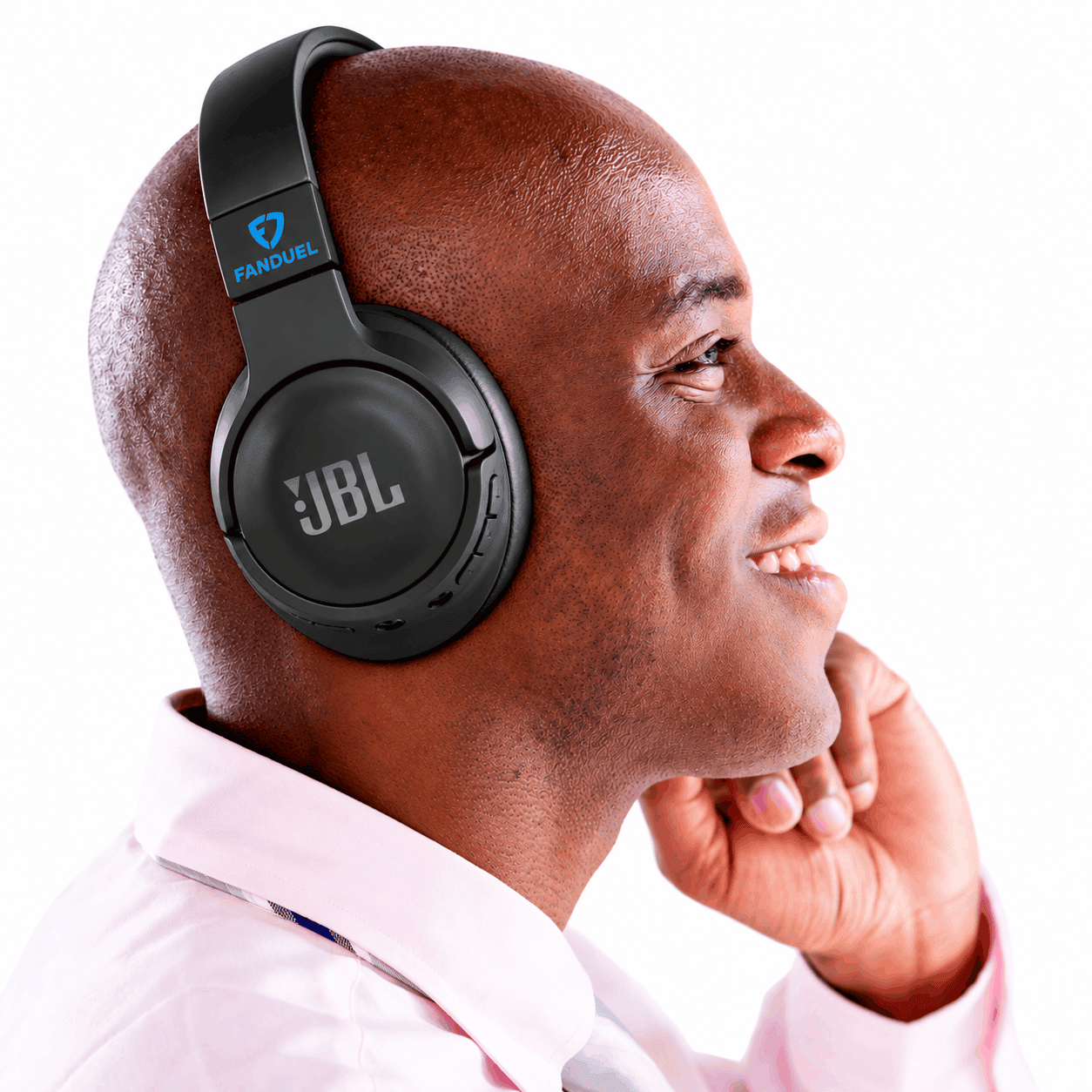 Black JBL Tune 720BT wireless over-ear headphones with a custom blue FanDuel logo on the headband, worn by a smiling man in a light pink shirt.